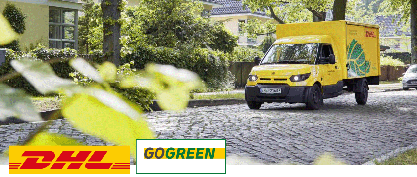 Автомобиль DHL GoGreen на дороге между деревьями